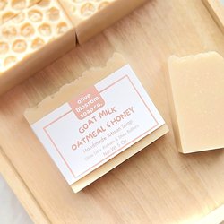 A luxurious bar of Goat milk, oatmeal and honey soap on a wooden tray. 
